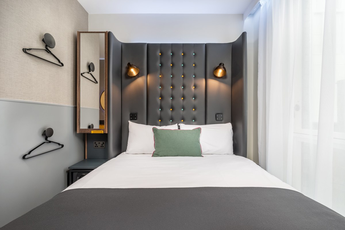 Cozy double bedroom featuring a comfortable bed with pillows and soft lighting at Point A Hotel Shoreditch